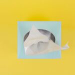 white paper boat on yellow surface