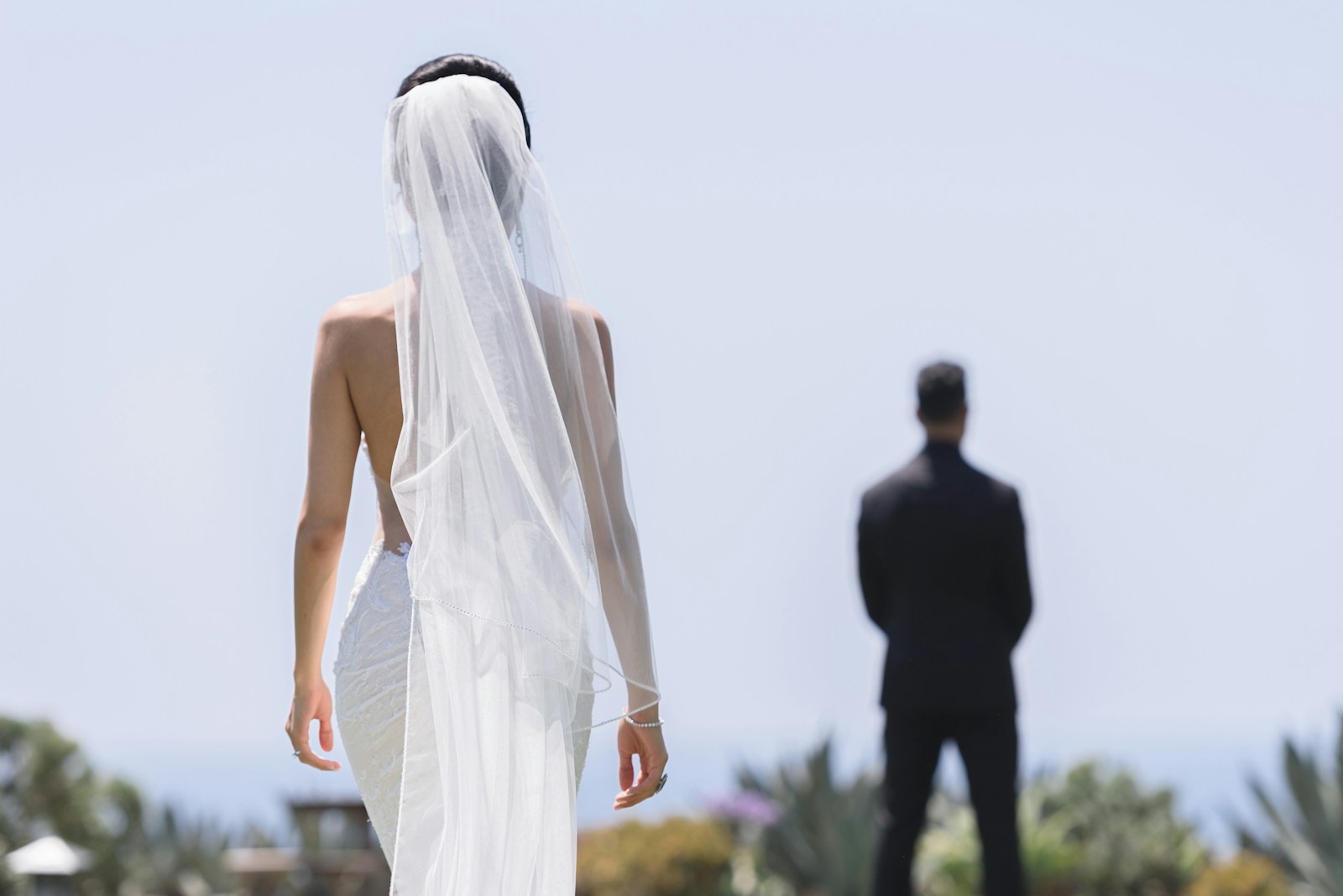 a woman in a wedding dress standing next to a man in a suit
