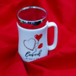 a red and white coffee mug with a heart on it