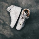 pair of white Nike high-top shoes